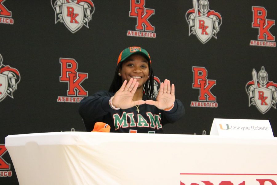Senior Jasmyne Roberts poses to represent University of Miami after signing her letter of intent.