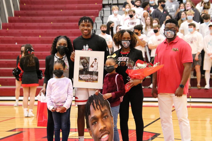 Senior Kenny Patterson,  number four, poses with his family for senior night.