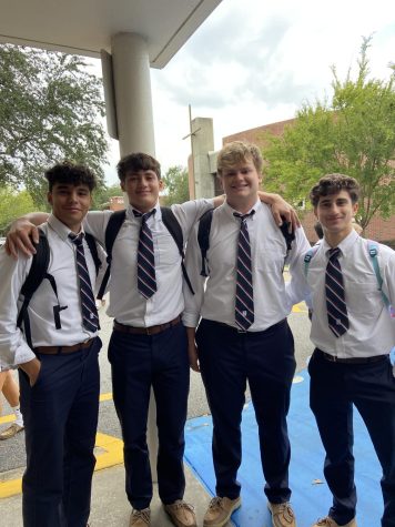 Group of senior boys standing outside of the 200 building in their senior ties.
