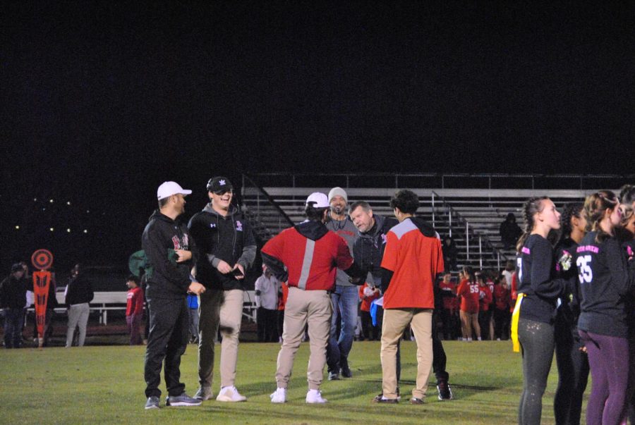 Senior coaches conversing with the game refs