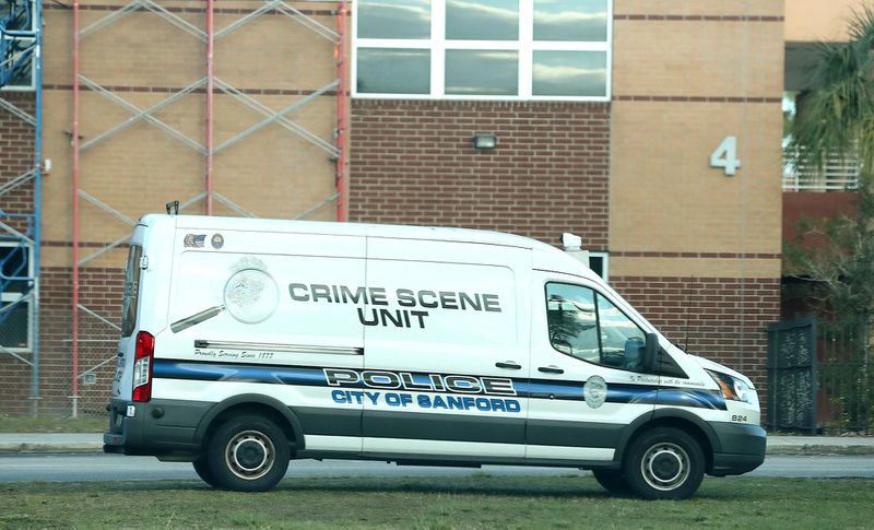 Crime unit vehicle sets up post outside the school following the shooting. 