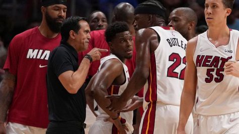 Heat players on the sideline with their coach, Erik Spoelstra.