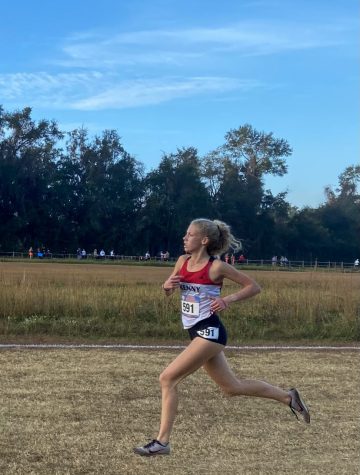Junior Davis Johnson races her second mile at the states course.