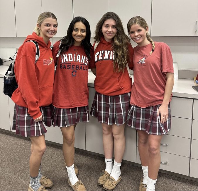 Seniors Reese Mohler, Haley Samaan, Isabelle Snyder and Mary Melville wearing red. 