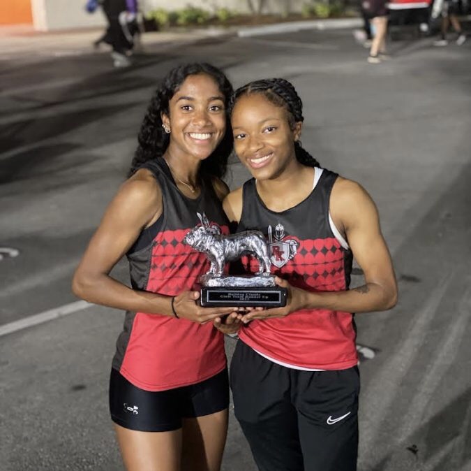 Seniors Gabby Johnson (left) and Ka’myya Haywood (right) holding the runner up trophy after their races. (Photo courtesy of Loren James)