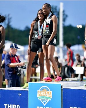 Gabrielle Johnson (left) and Ka’Myya Haywood (right) stand on the podium after their wins (photo courtesy Loren James).