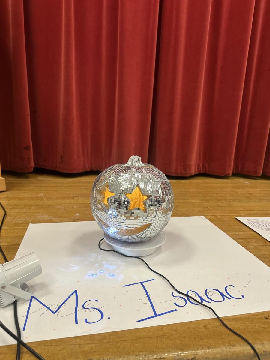 English teacher Grace Isaacs pumpkin, which rotates and has a light reflecting off of it, is a reference to “mirrorball.”