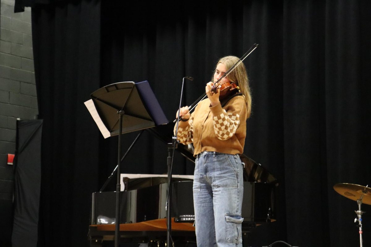 Senior Mary Clare Stinneford lost in concentration as she plays a classical piece on her violin