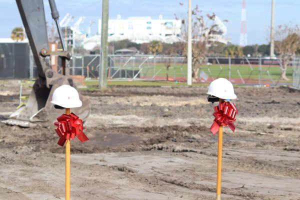 Shovels tied with bows, are used to celebrate the breaking of ground for the new athletic building.