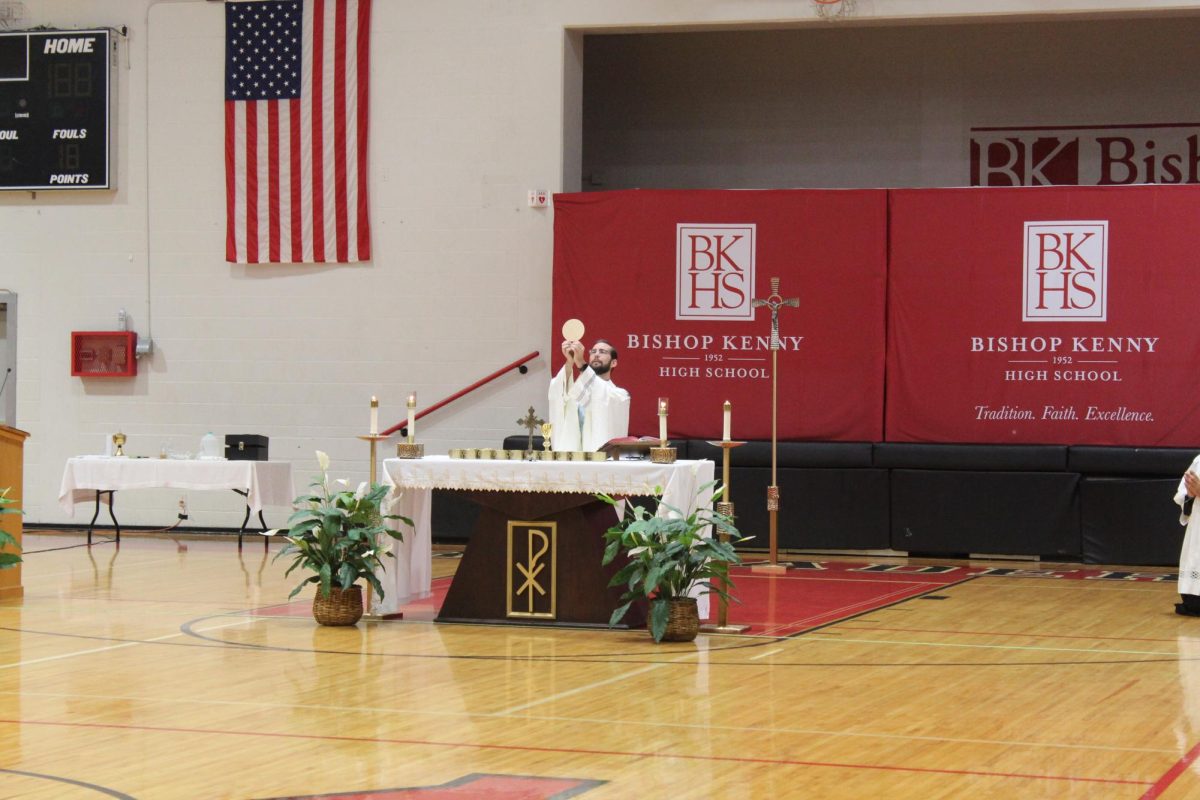 Father Clay raising the Eucharistic during the consecration.