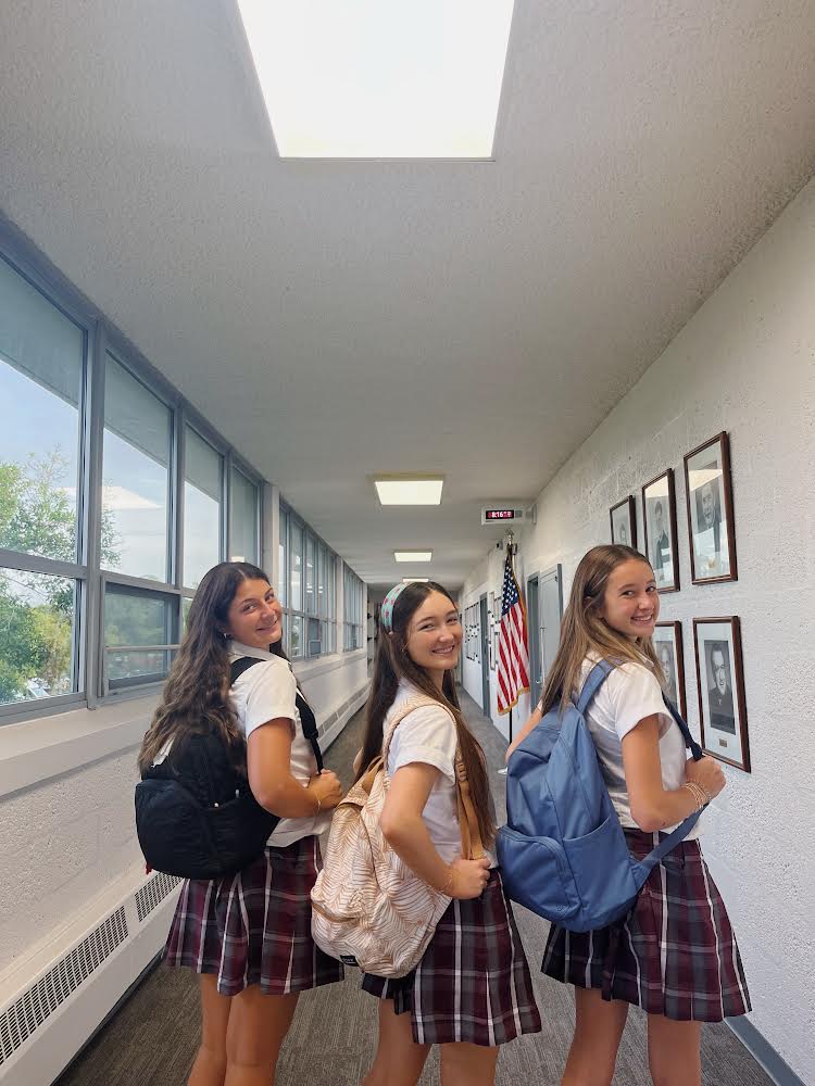 Juniors Becca Moody (left), Megan Mathew’s (middle), and Kate Reichard (right) show off their back-to-school backpacks