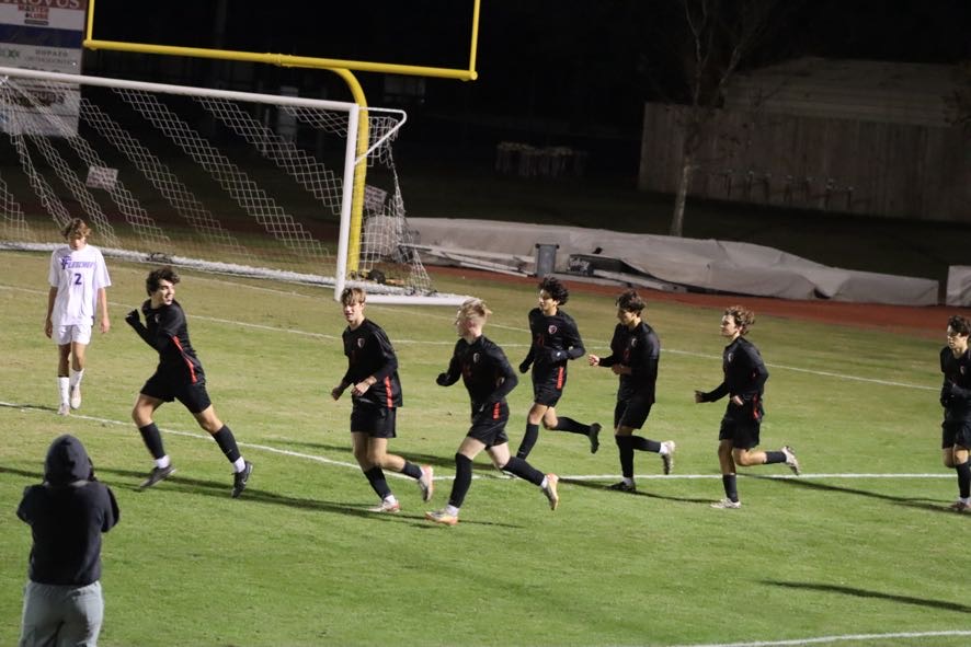 The team celebrates following the Crusader’s goal.