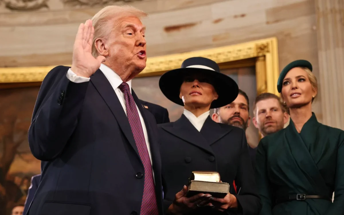 President Trump taking his oath which enters him into office. He decided to not place his hand on the Bible, which is allowed.