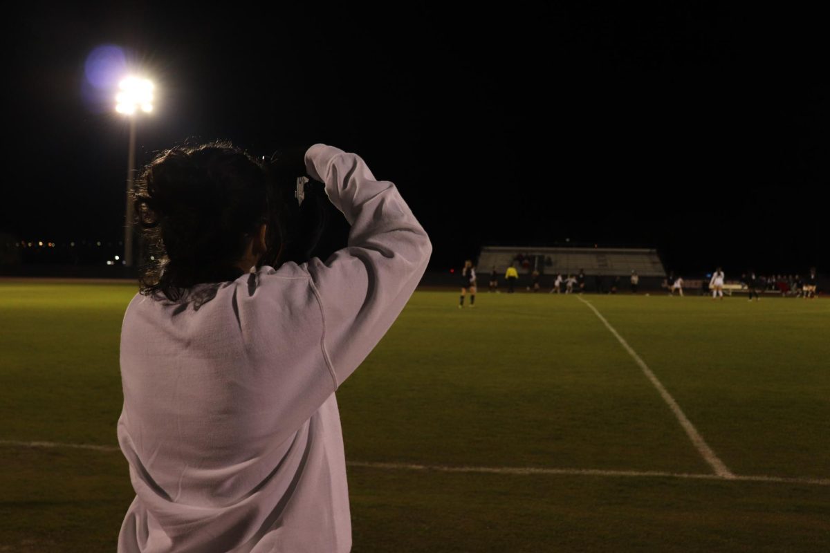 Pinate takes pictures at girls soccer game